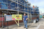 Joel James outside St. Monica's Church-in-Wales Primary School