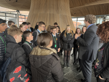 Joel speaking with students of his old school, Bryn Celynnog, in the Senedd