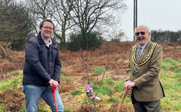 Joel James with Cllr David Stone planting a plum tree at Tir Y Craig - Tonteg