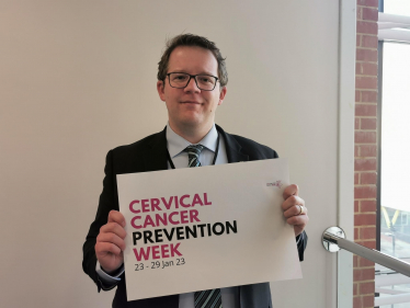 Joel James with Cervical Cancer Prevention Week sign 