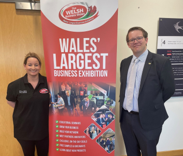 Joel James MS with the The Welsh Business Show Sign 